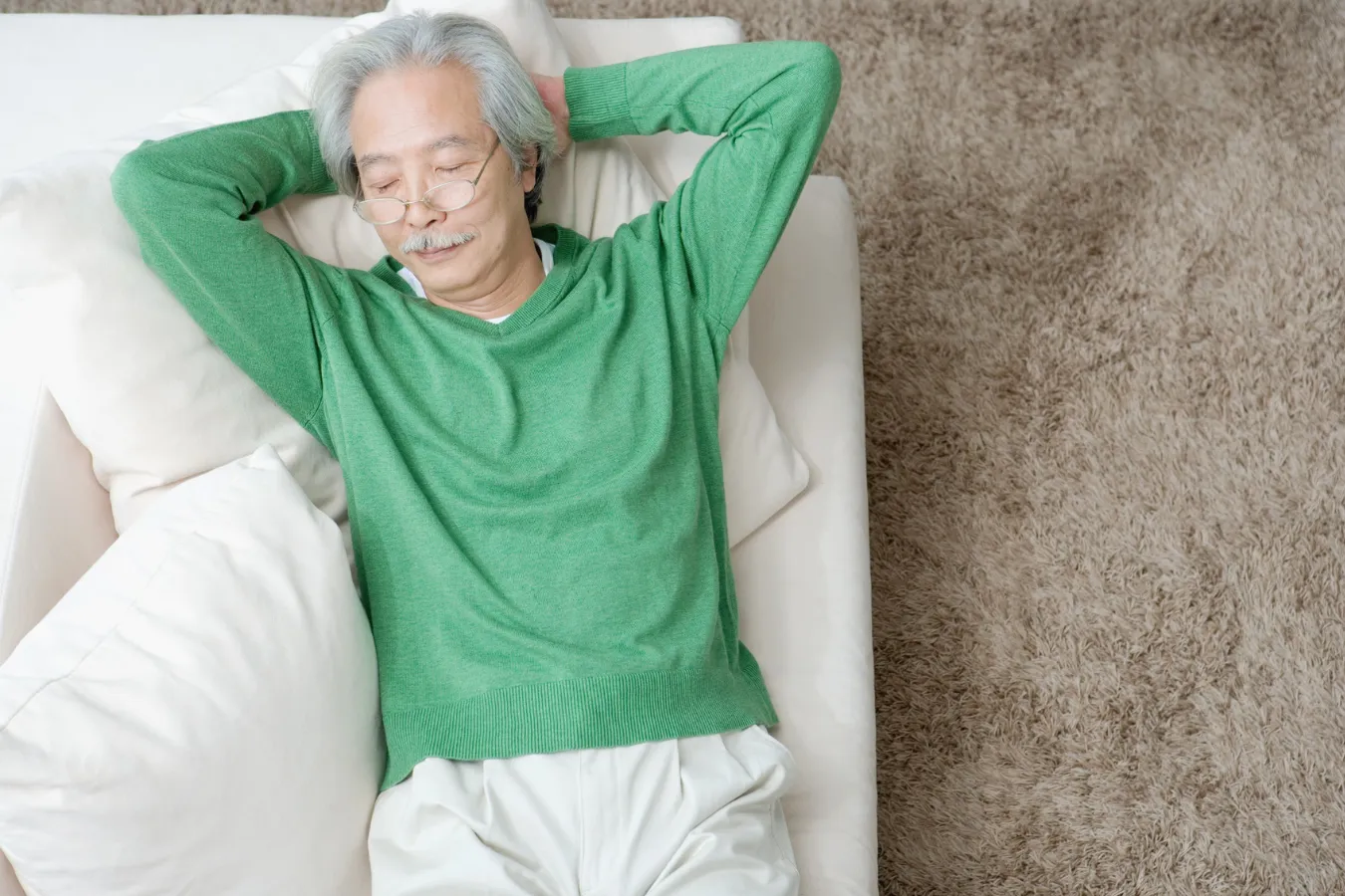 Aerial View of man sleeping on bed